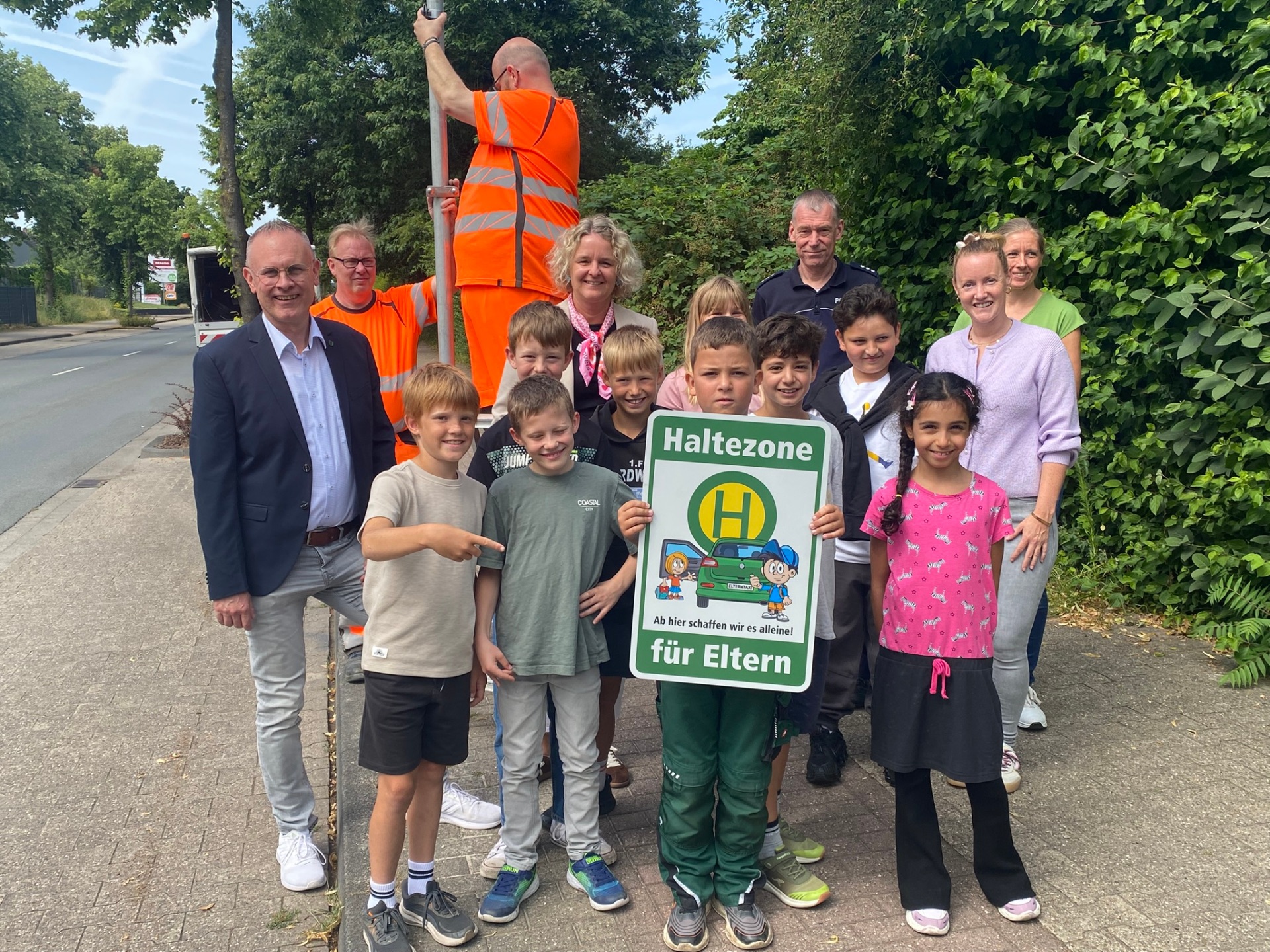 Gruppenbild vor dem Schild