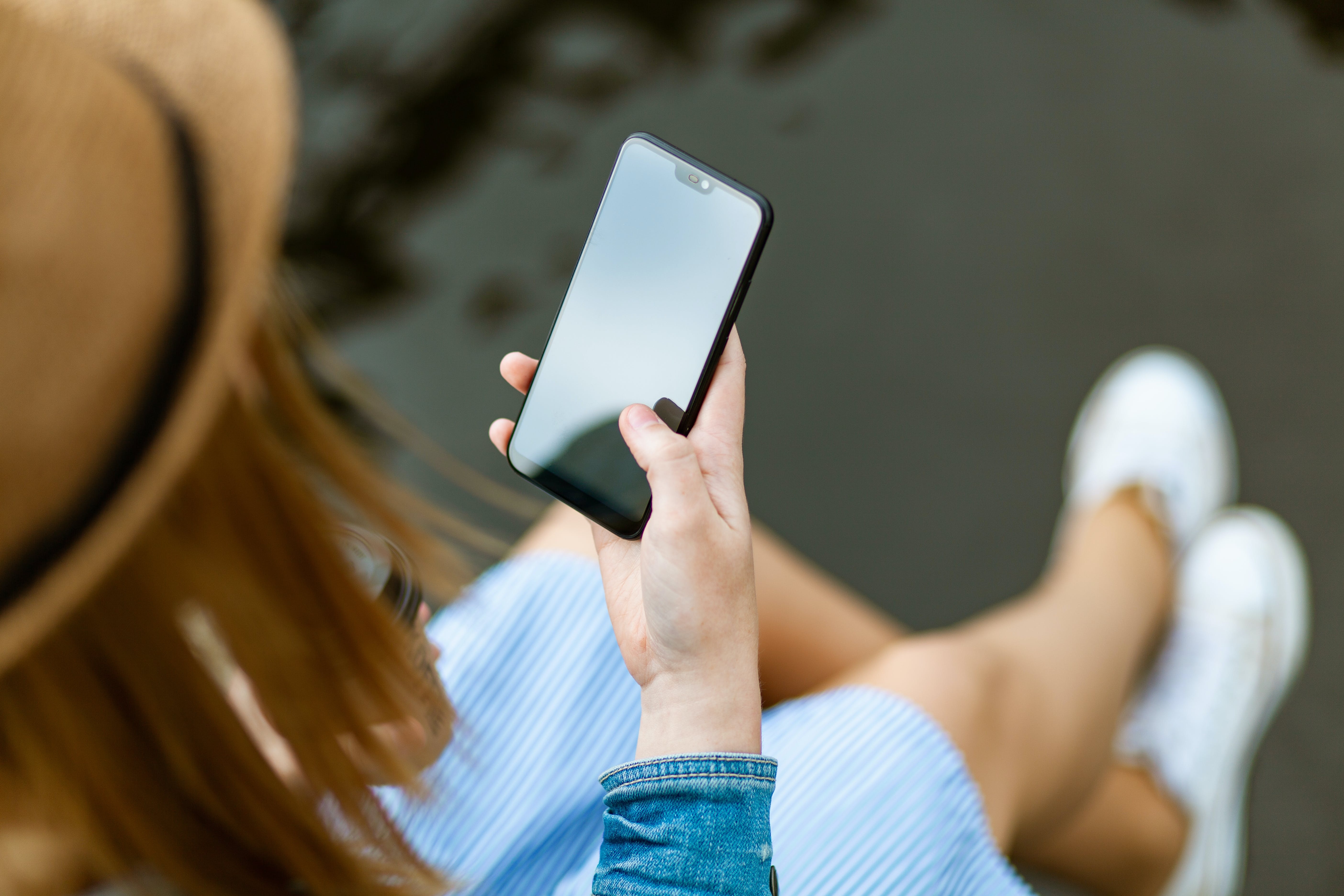 Person mit Smartphone in der rechten Hand