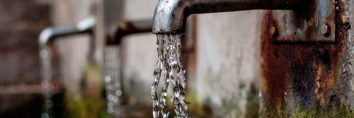 Drei Wasserhähne an einer Mauer